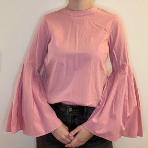 Pink blouse with bell sleeves and lace up back